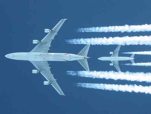 Shot of a EK/Atlas Air 747 (2000ft above us) being chased by EK B777-200 (A6-EML, 4000ft above us) right at its tail. Captured out of a EK (now thats coincidence...) B777 flightdeck (through left #1 window upwards - thats why the neck was twisted Wink. Us at FL340, 747 at 360, other B777 at 380.