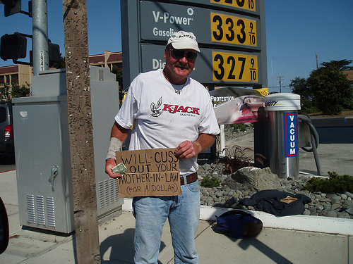 homeless people holding funny sign